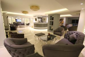 a living room with couches and chairs and a living room at Ankara Gold Hotel in Ankara