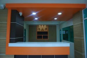 a kitchen with an orange counter in a building at A.D. Living in Hua Hin +32 photos