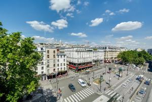a view of a city street with cars and buildings at La Villa Royale in Paris