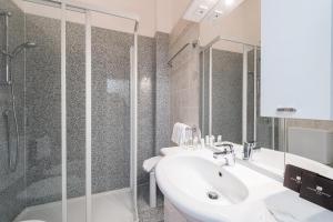 a bathroom with a sink and a shower at Villa Belvedere Como Lake Relais in Argegno