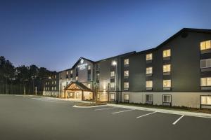 an empty parking lot in front of a building at WoodSpring Suites Savannah Pooler in Savannah