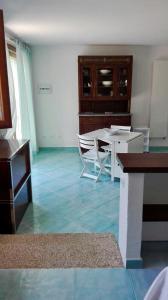 ein Wohnzimmer mit einem weißen Tisch und Stühlen in der Unterkunft Valle dell'Erica in Valle Dell’Erica