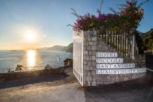 a fence with flowers on it next to the ocean at Hotel Piccolo Sant'Andrea in Praiano