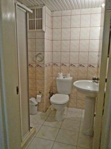 a bathroom with a toilet and a sink at Kleopatra Saray Hotel in Alanya