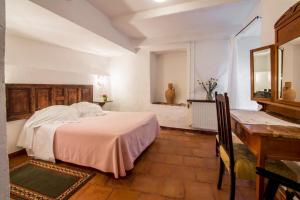 a hotel room with a bed and a dresser at Posada San José in Cuenca