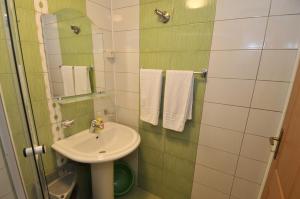 a small bathroom with a sink and a mirror at Marušić Apartments in Vlasic +28 photos