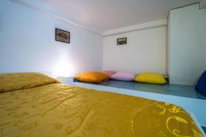 a bedroom with two pillows sitting on the floor at B&B La Melodia in Anacapri