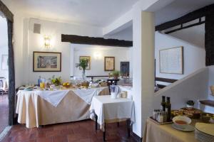 a dining room with two tables with white table cloth at Posada San José in Cuenca +17 photos