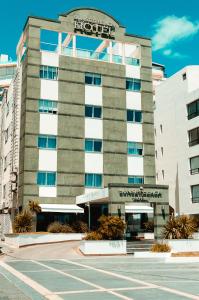 a building with a sign on the front of it at Hotel Sunset Beach in Punta del Este