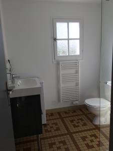 a bathroom with a sink and a toilet and a window at Maison Bord de Mer au Vieil 3 étoiles in Noirmoutier-en-l'lle +40 photos