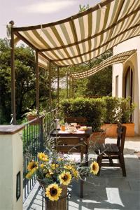 een patio met een tafel en stoelen onder een pergola bij Il Pino Bioagricoltura in Terranuova Bracciolini