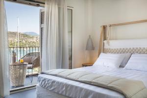 a bedroom with a bed and a balcony at Argostoli Marina Suites in Argostoli