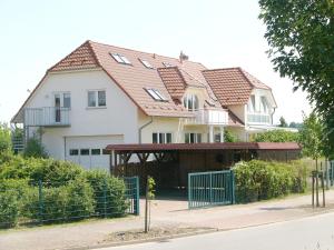 a large white house with a red roof at Fernblick in Neu Schloen