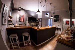 a kitchen with a bar with stools in a room at Balate Maqueda B&B in Palermo