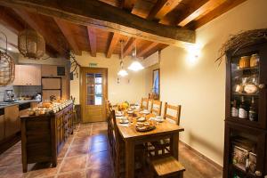 a kitchen with a table and chairs in a room at Ekolanda in Esnoz