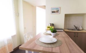 uma cozinha com uma mesa de madeira com placas em Cozy Apt in the Heart of Old Town em Vilnius