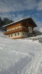 a building on top of a snow covered mountain at Weitblick Appartements in Bad Hofgastein