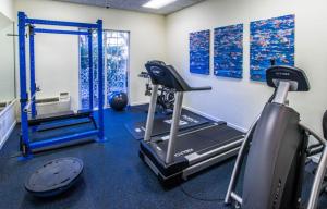 a fitness room with a treadmill and a gym at Trianon Bonita Bay Hotel in Bonita Springs