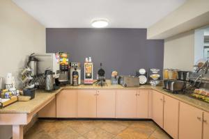 a kitchen with white cabinets and a counter top at Microtel Inn Bowling Green in Bowling Green