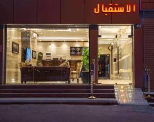 a store front window of a furniture store at night at منازل الورد للشقق المخدومه Tabuk Risdance in Tabuk