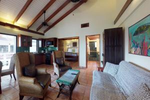 a living room with a couch and chairs and a table at Condo #31 @ Beachside Villas in Placencia