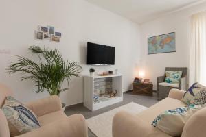 a living room with two chairs and a flat screen tv at Villa Kalura in Klanac