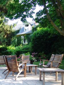 - un groupe de chaises en bois, une table et un banc dans l'établissement Hotel Restaurant Chavant, à Bresson