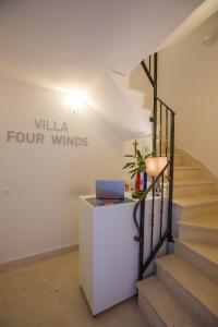 
a staircase leading up to a large white refrigerator at Villa Four Winds in Dubrovnik
