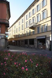 a large building with pink flowers in front of it at Borgo San Leonardo in Bergamo