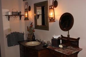
a bathroom with a sink, mirror, and a large mirror at Adobe Village Inn in Sedona
