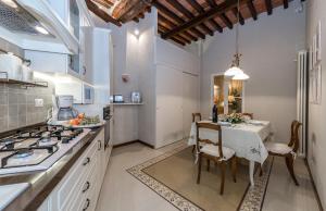 a kitchen with a table and a dining room at Appartamento San Michele in Lucca