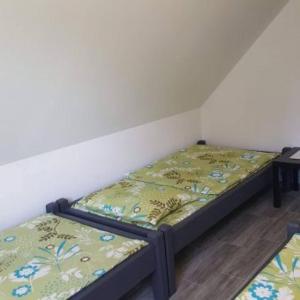 two twin beds sitting in a room with a wall at Agroturystyka,, Ranczo Kruszynki" in Stronie Śląskie +65 photos