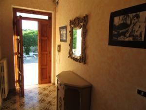 a room with a mirror on the wall and a door at Le dimore di Flora Charme in Monopoli