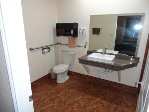 a bathroom with a sink and a toilet at Americas Best Value Inn - Brownsville in Brownsville
