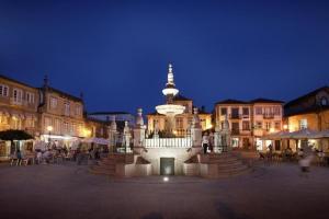 a clock tower in the middle of a town at night at Cabedelo Spot - Beachside Vacations in Viana do Castelo