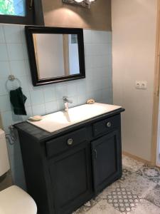 a bathroom with a black sink and a mirror at Patak Apartman, Diszel in Tapolca +66 photos