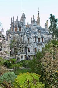 an old castle in the middle of a garden at Páteo Badajoz in Sintra