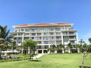 a large building with a lawn in front of it at One Bedroom Apartment with Sea View in Danang