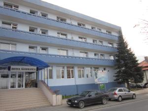 two cars parked in front of a building at Germanea Hotel in Sapareva Banya