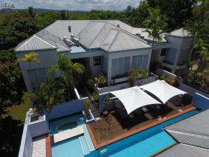 an aerial view of a house with a swimming pool at Silkari The Pavilions in Port Douglas