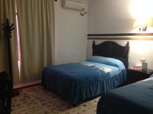 Katil atau katil-katil dalam bilik di Hotel Claudia