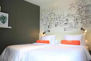 Voodi või voodid majutusasutuse HARRIS Hotel & Conventions Malang toas
