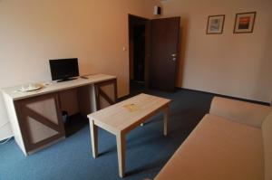 a room with a desk with a computer and a table at Penzion Solisko in Zázrivá