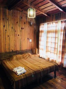 a bedroom with a bed with towels on it at Aqua De Vida in Bhowāli