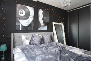 a bedroom with black and white pictures on the wall at Casa Mia - Modern Luxury Apartament in Bucharest