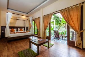 une chambre d'hôtel avec un lit et un balcon dans l'établissement Lanta Klong Nin Beach Resort, à Ko Lanta 59 autres photos