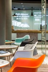 a room with tables and chairs and a sign at ibis Berlin City Potsdamer Platz in Berlin
