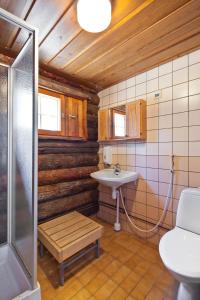 a bathroom with a sink and a toilet at Holiday Club Pyhäniemi Cottages in Kihniö +63 photos