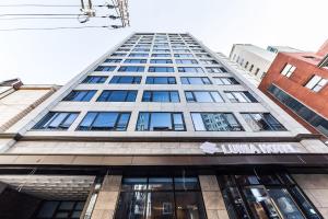 a tall building with a lot of windows at Jongno Hotel Lumia in Seoul