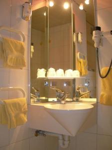 a bathroom with a sink and a mirror at Hotel Crystal Interlaken in Interlaken